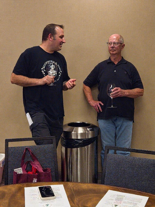 Discussion Two men discuss the wine
